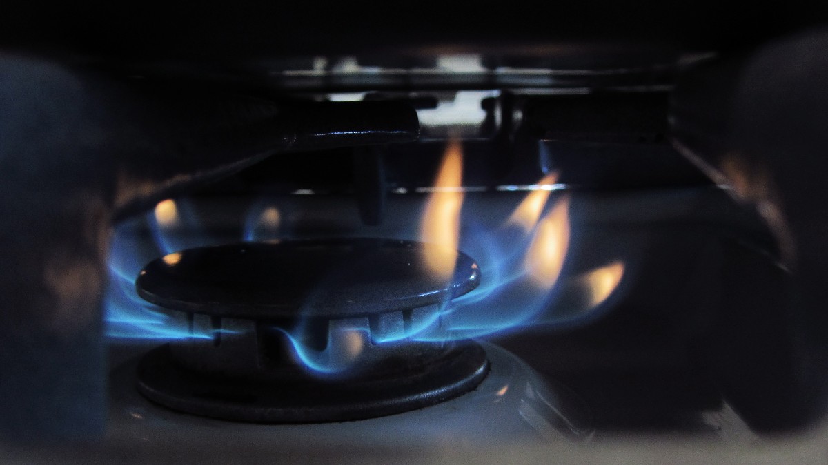 Blue flame on a gas stove burner.