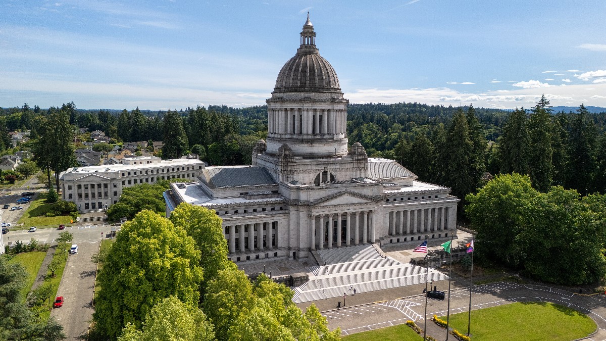 Aerial view of the Washington State Capitol campus in Olympia in summer, with the domed Legislative Building at its center.